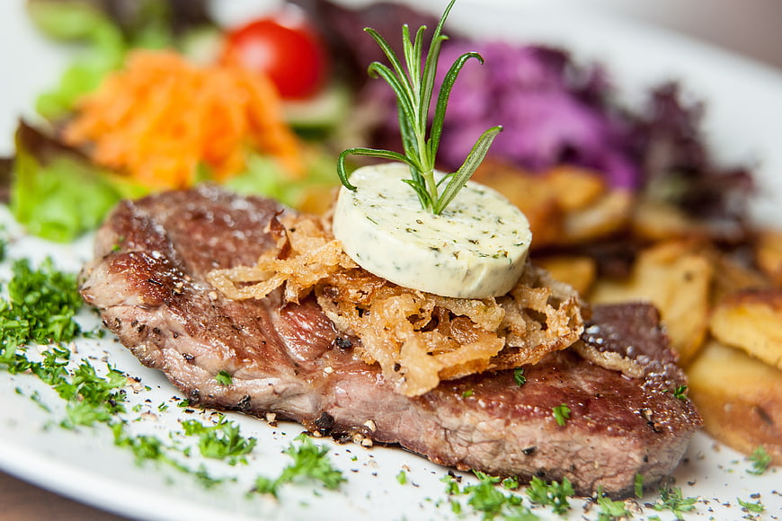Gourmet Steak with Herb Butter and Rosemary Garnish