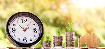 Financial Growth Concept with Clock, Coins, and House Model
