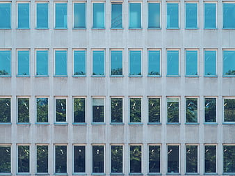 Modern building facade with grid of blue reflective windows