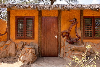 Rustic African Hut with Thatched Roof and Wooden Door