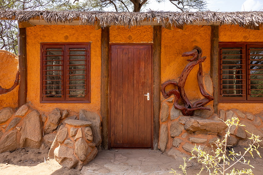 Rustic African Hut with Thatched Roof and Wooden Door