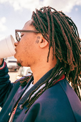 Man with Dreadlocks Drinking Coffee Outdoors