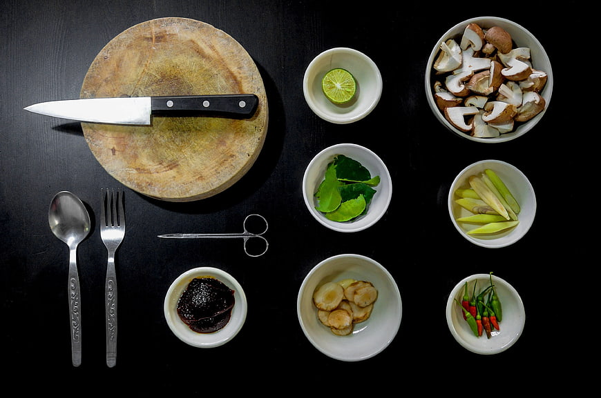 Top View of Asian Cooking Ingredients and Kitchen Tools on Black