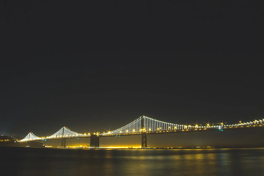 Istanbul Bosphorus Bridge illuminated at night with water reflections