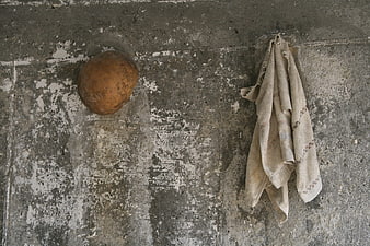 Rusty bucket and towel on weathered concrete wall