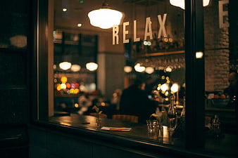 Night view of restaurant window with relax sign