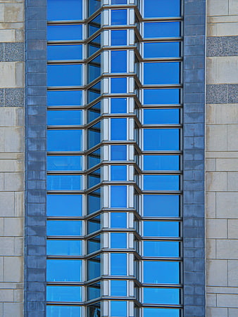 Modern Blue Glass Building Facade with Geometric Window Pattern