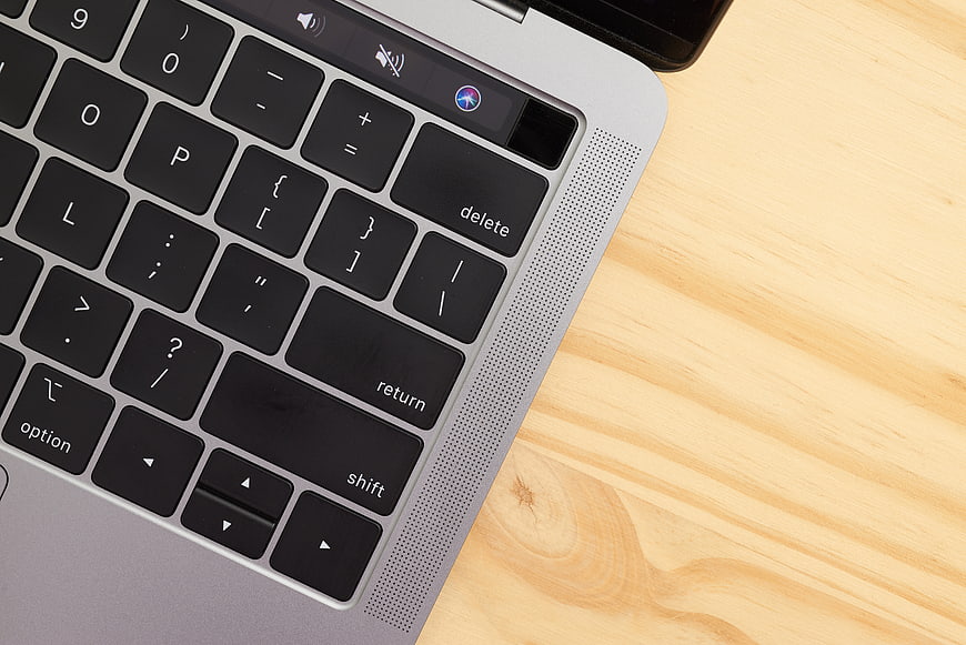 Close-up of laptop keyboard on wooden desk
