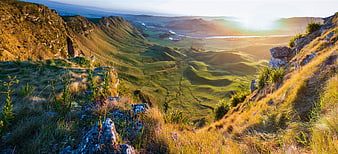 Panoramic View of Rolling Green Hills and Valley at Golden Hour