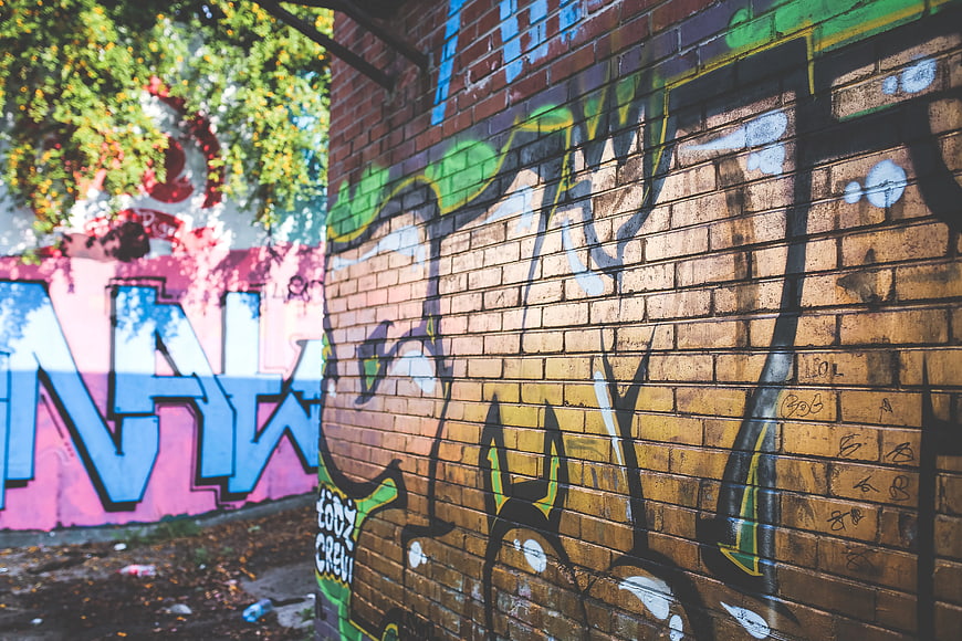 Colorful graffiti art on brick wall in urban alley