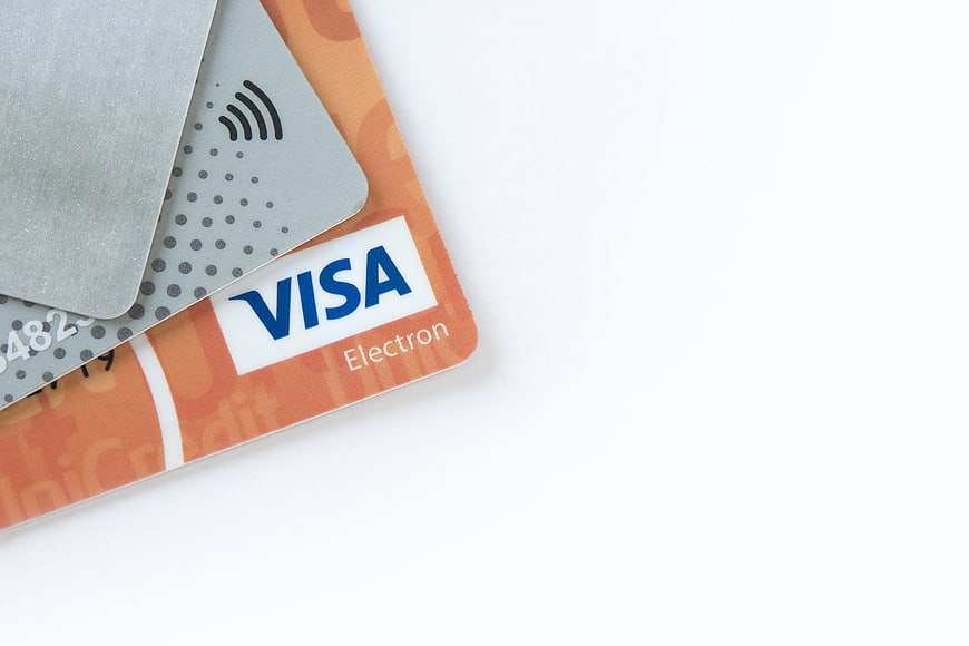 Stack of Credit Cards with Visa Logo on White Background