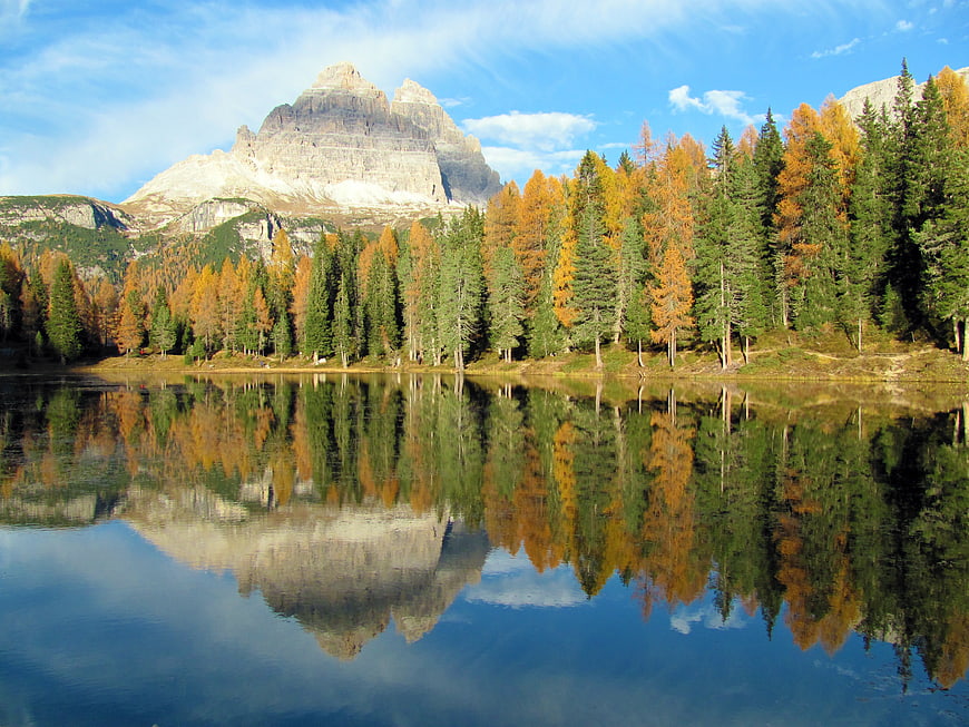 Autumn Mountain Lake Reflection with Golden Larch Forest