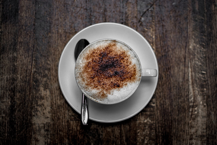 Top View Cappuccino with Cocoa Powder on Wooden Table