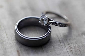 Silver Wedding Bands and Diamond Ring on Wood