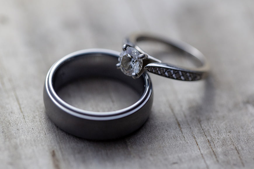 Silver Wedding Bands and Diamond Ring on Wood