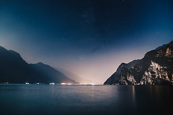 Serene Night Landscape of Lake Between Mountains with Starry Sky