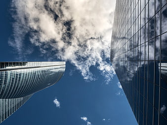 Worm's eye view of modern skyscrapers against blue sky