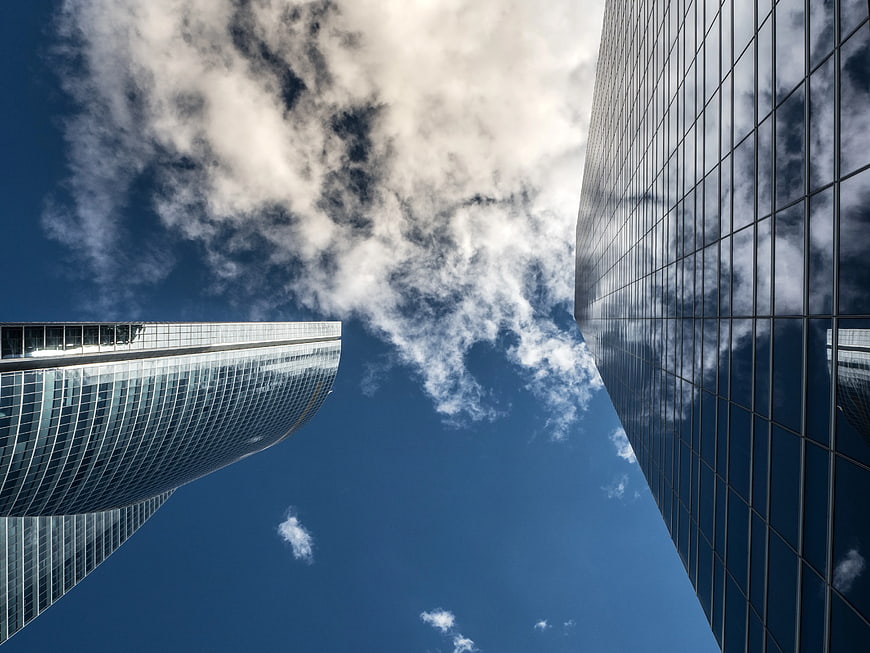 Worm's eye view of modern skyscrapers against blue sky