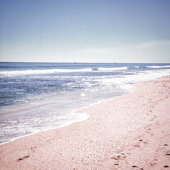 Vintage Film Photo of Pink Sand Beach and Blue Ocean Waves