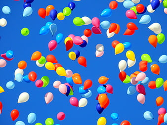 Colorful Balloons Floating Against Clear Blue Sky