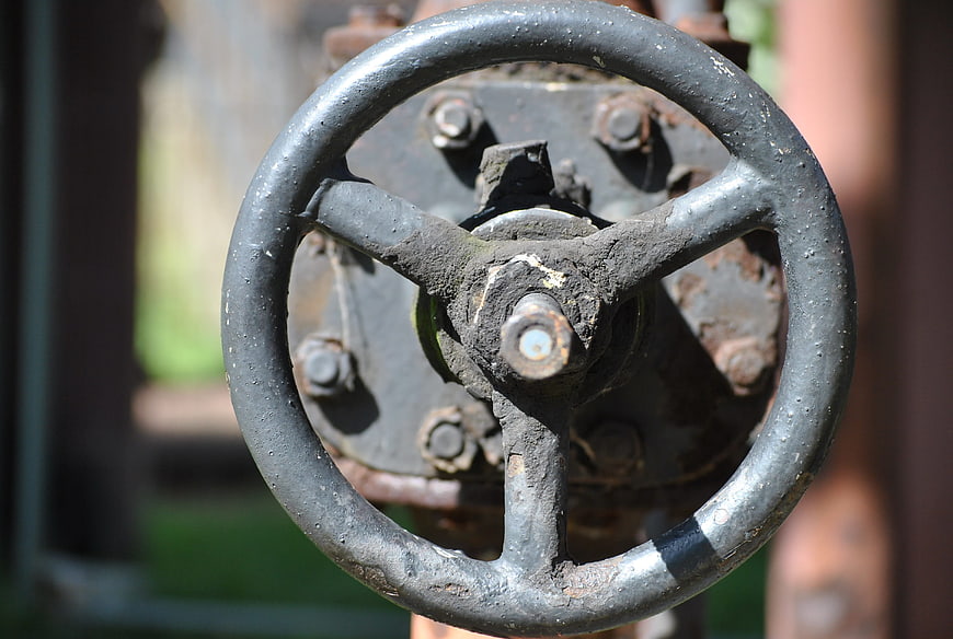 Close-up of rusty industrial valve wheel