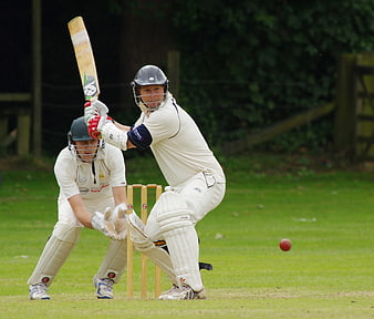 Cricket Batsman Playing Shot with Wicketkeeper Behind Stumps