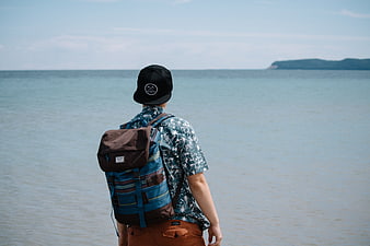 Man with Backpack Looking at Ocean View