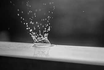 Black and white water drop splash on surface