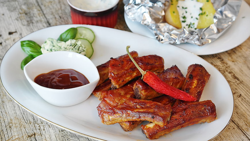 Grilled Spare Ribs With BBQ Sauce And Sides On White Plate