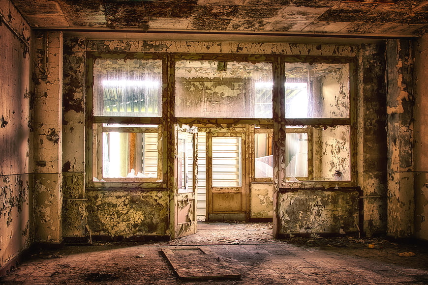 Abandoned Interior Room with Peeling Paint and Decaying Walls