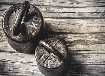 Vintage Cast Iron Weights on Rustic Wooden Background