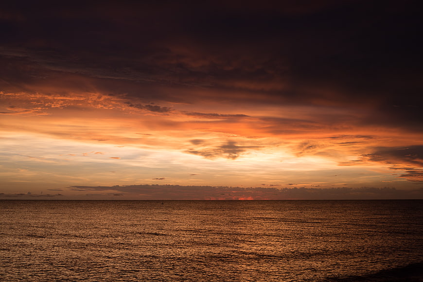 Dramatic Orange Sunset Over Calm Ocean Horizon