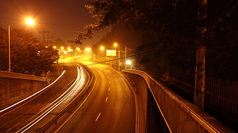 Night highway with long exposure car light trails