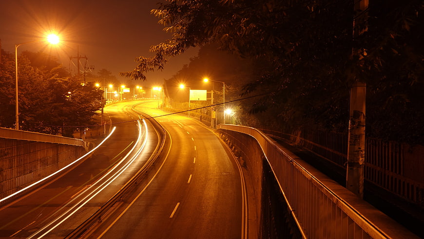 Night highway with long exposure car light trails