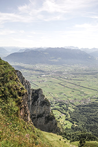 Panoramic Alpine Valley View from Rocky Cliff Edge