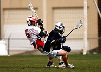Two Male Lacrosse Players Competing on Grass Field