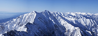 Snow-Covered Mountain Range Panorama Under Clear Blue Sky