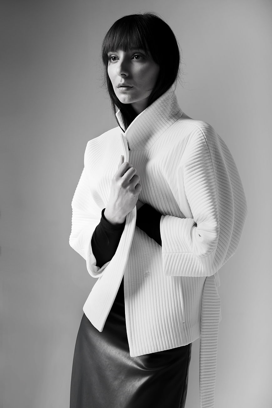 Fashion Portrait of Woman in Pleated White Jacket