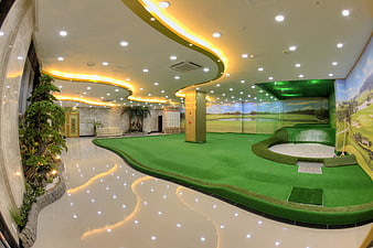 Indoor Screen Golf Facility With Putting Green And Luxury Lobby