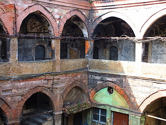 Old brick arches of a dilapidated historical building courtyard