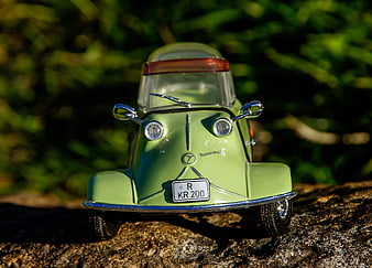 Green Microcar Model on Tree Bark