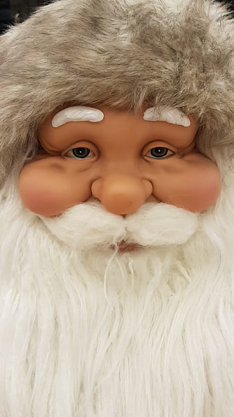 Close-up of a Santa Claus mask with white beard and fur hat