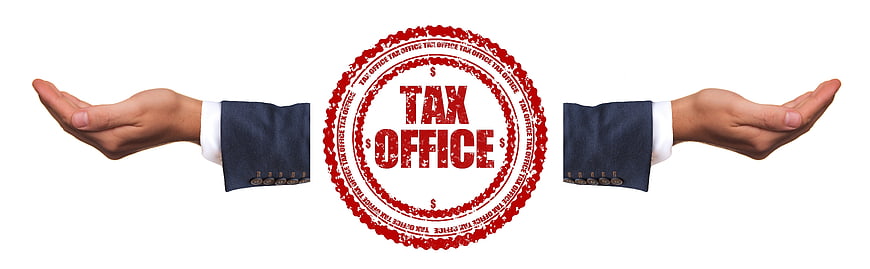 Business hands presenting red tax office rubber stamp