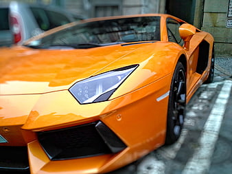Close-up of Orange Lamborghini Aventador on City Street
