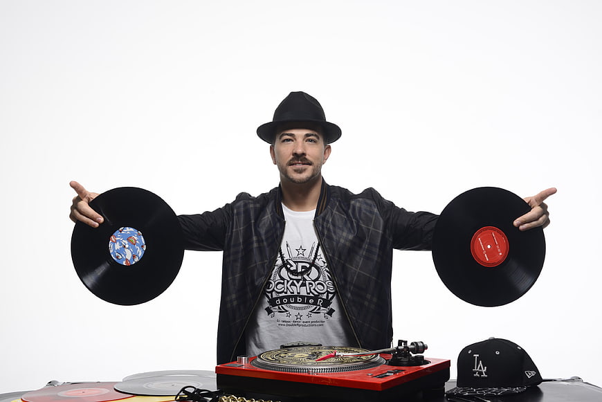 DJ Holding Vinyl Records With Turntable