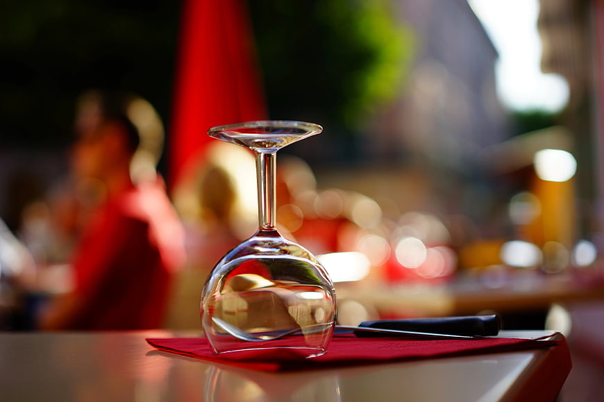 Empty Wine Glass on Red Napkin at Outdoor Cafe