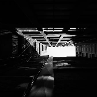 Dramatic black and white architectural perspective of concrete beams