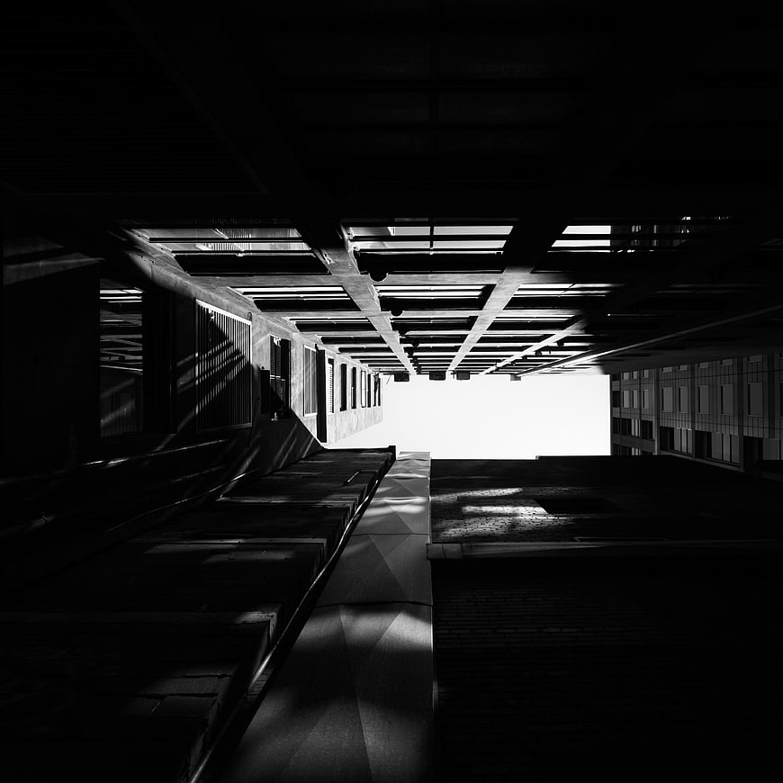 Dramatic black and white architectural perspective of concrete beams