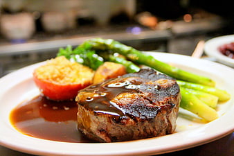 Grilled Steak with Asparagus and Roasted Tomato on White Plate