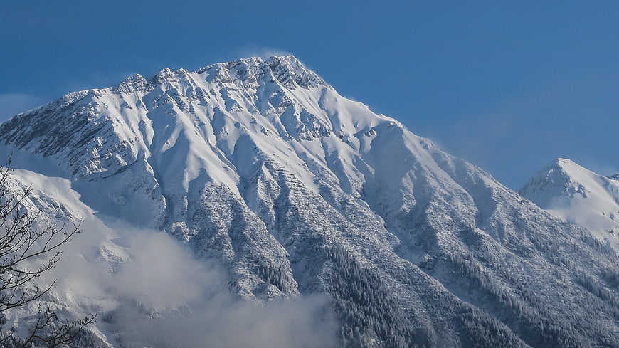 Majestic Snow-Covered Mountain Peak with Blue Sky